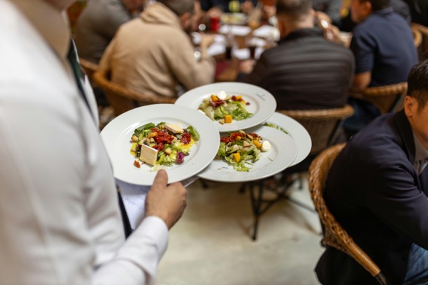 Professional catering staff serving guests at a Gather event